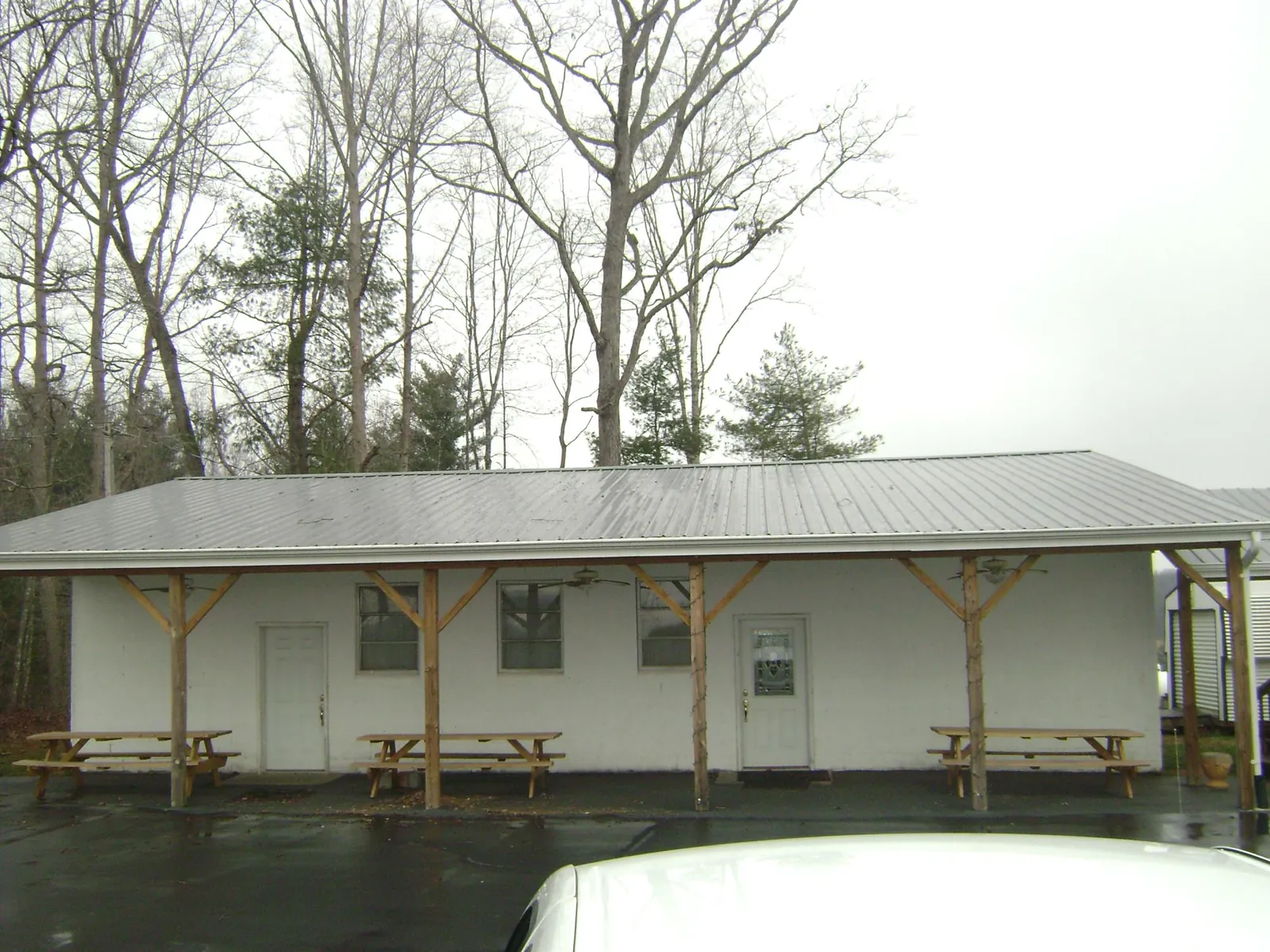Gray metal roof over a block building with a timber post porch in Fleetwood